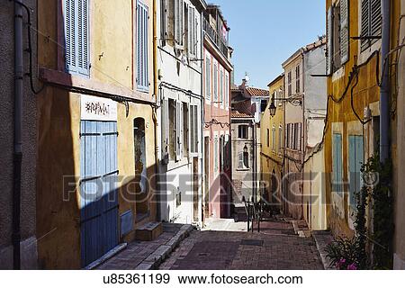 Stock Photo - Colorful house exteriors along alleyway, Marseille, France. Fotosearch