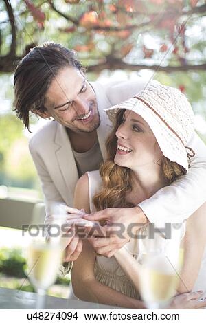 Couple getting engaged in garden restaurant View Large Photo Image Picture - Couple getting engaged in garden restaurant. Fotosearch