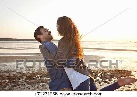 Couple having fun on beach View Large Photo Image Stock Photograph - Couple having fun on beach. Fotosearch