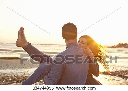 Couple having fun on beach View Large Photo Image Stock Photography - Couple having fun on beach. Fotosearch