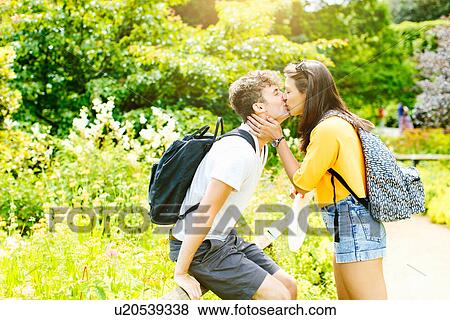 Stock Photo - Couple kissing in the park. Fotosearch