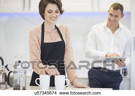 Couple taking a coffee break in kitchen View Large Photo Image Picture - Couple taking a coffee break in kitchen. Fotosearch