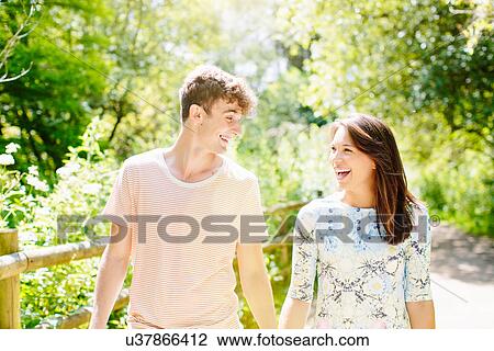 Stock Image - Couple walking in the park. Fotosearch