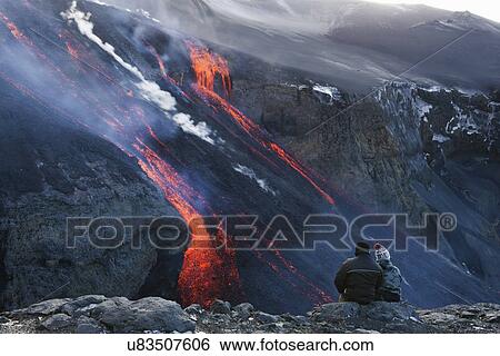 Couple watching volcanic lava, Fimmvorduhals, Iceland View Large Photo Image Stock Photograph - Couple watching volcanic lava, Fimmvorduhals, Iceland. Fotosearch