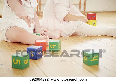 Cropped shot of baby sisters playing with building blocks View Large Photo Image Stock Image - Cropped shot of baby sisters playing with building blocks. Fotosearch