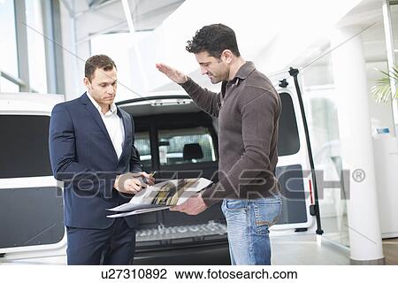 Customer questioning salesman in car dealership View Large Photo Image Stock Image - Customer questioning salesman in car dealership. Fotosearch