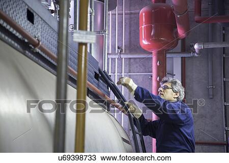 Engineer climbing steps in power station View Large Photo Image Stock Image - Engineer climbing steps in power station. Fotosearch