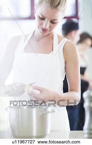Female chef peeling potatoes in commercial kitchen View Large Photo Image Stock Photo - Female chef peeling potatoes in commercial kitchen. Fotosearch