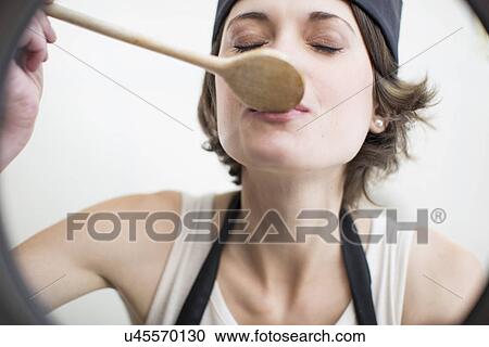 Female chef tasting food from saucepan in commercial kitchen View Large Photo Image Stock Image - Female chef tasting food from saucepan in commercial kitchen. Fotosearch