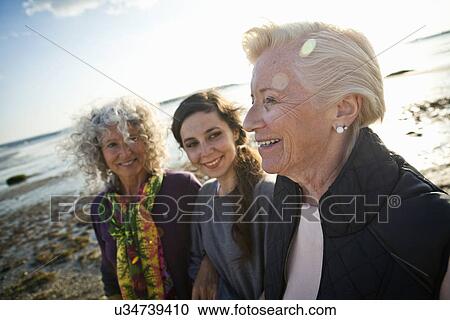 Female family members chatting on beach View Large Photo Image Stock Image - Female family members chatting on beach. Fotosearch