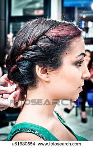Female hairdresser braiding young woman's hair in hair salon View Large Photo Image Picture - Female hairdresser braiding young woman's hair in hair salon. Fotosearch