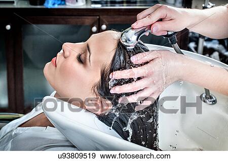 Female hairdresser rinsing young woman's hair in hair salon View Large Photo Image Stock Photo - Female hairdresser rinsing young woman's hair in hair salon. Fotosearch