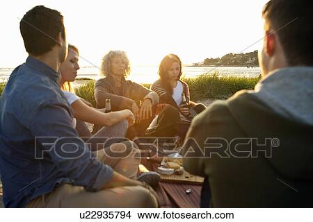 Picture - Five adult friends having picnic on Bournemouth beach, Dorset, UK. Fotosearch