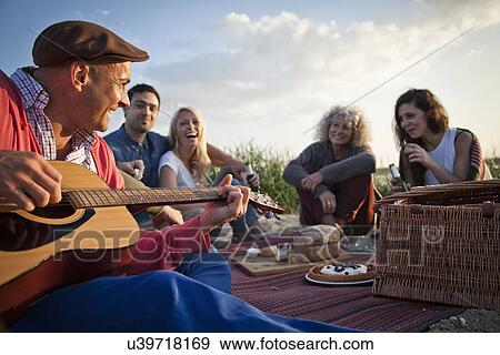 Five adult friends picnicing on Bournemouth beach, Dorset, UK View Large Photo Image Stock Photo - Five adult friends picnicing on Bournemouth beach, Dorset, UK. Fotosearch