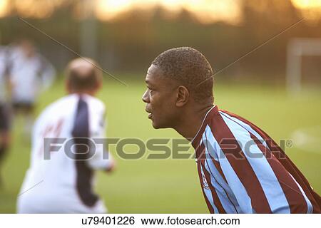 Stock Photograph - Football player alert at game. Fotosearch