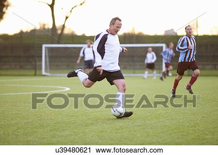 Football player kicking ball View Large Photo Image Stock Image - Football player kicking ball. Fotosearch