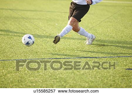 Football player kicking ball View Large Photo Image Stock Photo - Football player kicking ball. Fotosearch