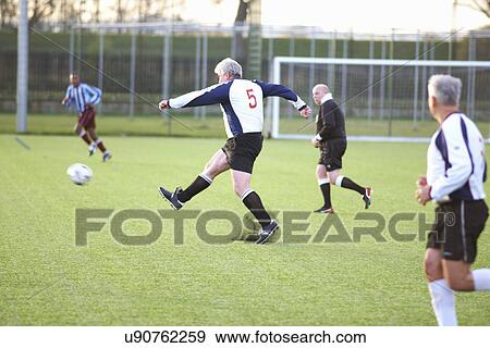 Football player kicking ball View Large Photo Image Stock Photo - Football player kicking ball. Fotosearch