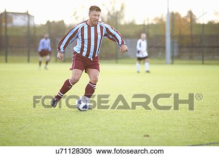 Football player kicking ball View Large Photo Image Stock Photography - Football player kicking ball. Fotosearch