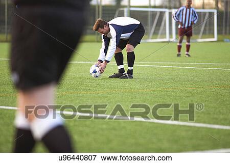 Football player positioning ball View Large Photo Image Stock Photo - Football player positioning ball. Fotosearch