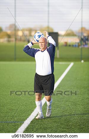 Football player throwing ball to start game View Large Photo Image Stock Photography - Football player throwing ball to start game. Fotosearch