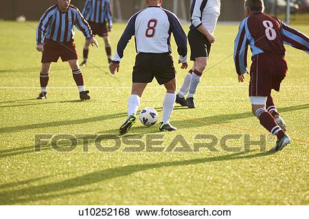 Stock Photo - Football player with possession of ball. Fotosearch