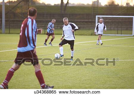 Football player with possession of ball View Large Photo Image Stock Photography - Football player with possession of ball. Fotosearch
