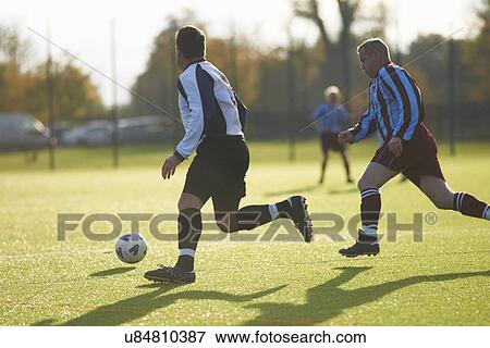 Stock Photo - Football players during game. Fotosearch