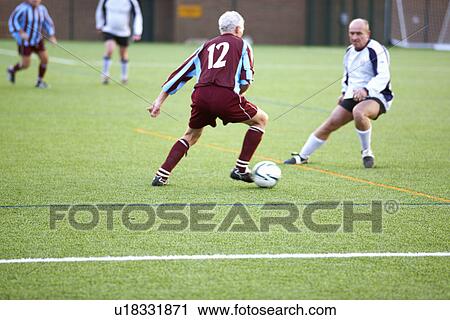 Football players fighting for ball View Large Photo Image Stock Image - Football players fighting for ball. Fotosearch