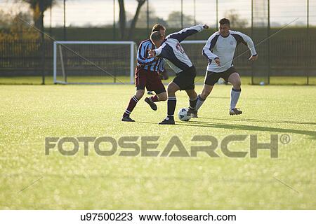 Football players fighting for ball View Large Photo Image Stock Image - Football players fighting for ball. Fotosearch