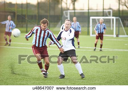 Football players fighting for ball View Large Photo Image Stock Photo - Football players fighting for ball. Fotosearch