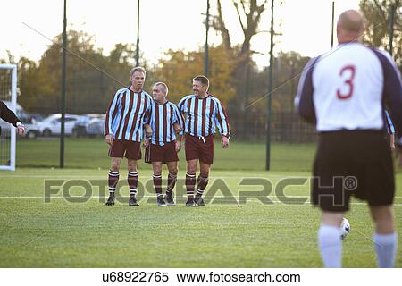 Stock Photography - Football players forming wall to defend free kick. Fotosearch