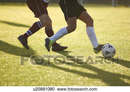 Stock Image - Footy players fighting for ball. Fotosearch