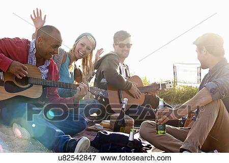 Four adult friends partying on Bournemouth beach, Dorset, UK View Large Photo Image Stock Photo - Four adult friends partying on Bournemouth beach, Dorset, UK. Fotosearch