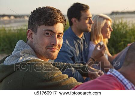 Four adult friends sitting on Bournemouth beach, Dorset, UK View Large Photo Image Stock Photo - Four adult friends sitting on Bournemouth beach, Dorset, UK. Fotosearch