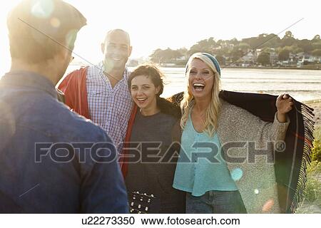 Four adult friends with picnic blanket on Bournemouth beach, Dorset, UK View Large Photo Image Stock Image - Four adult friends with picnic blanket on Bournemouth beach, Dorset, UK. Fotosearch