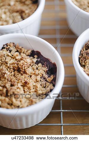 Stock Photo - Fruit crumble in ramekin. Fotosearch