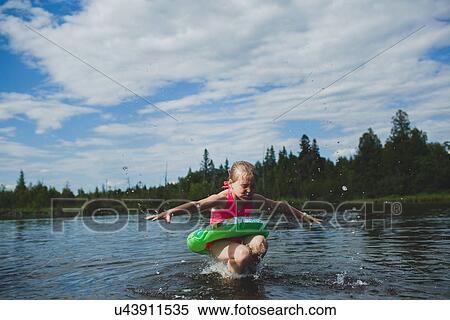 Girl with rubber ring jumping in Indian river, Ontario, Canada View Large Photo Image Stock Photography - Girl with rubber ring jumping in Indian river, Ontario, Canada. Fotosearch