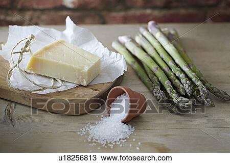 Stock Image - Grated parmesan and asparagus. Fotosearch