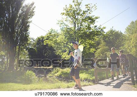 Group of boys walking on bridge View Large Photo Image Stock Photograph - Group of boys walking on bridge. Fotosearch