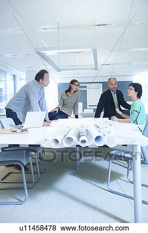Group of business people discussing plans View Large Photo Image Stock Photo - Group of business people discussing plans. Fotosearch