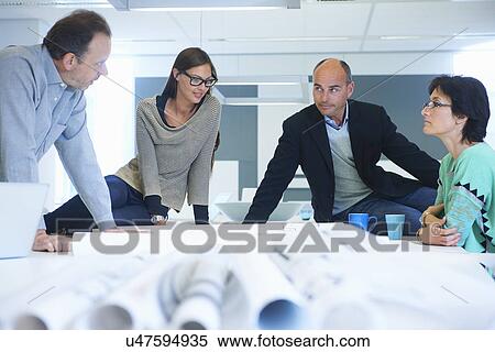 Stock Photography - Group of business people discussing plans. Fotosearch