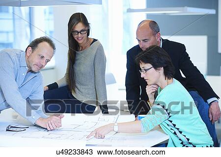 Group of business people looking at plans View Large Photo Image Stock Image - Group of business people looking at plans. Fotosearch