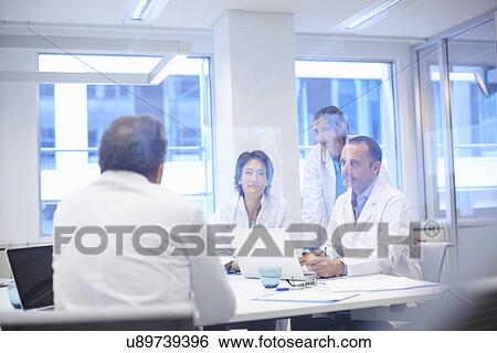 Stock Photograph - Group of doctors having discussion. Fotosearch