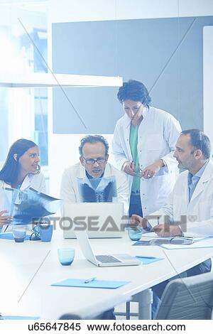 Group of doctors looking at x-rays View Large Photo Image Stock Photography - Group of doctors looking at x-rays. Fotosearch