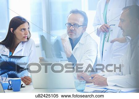 Group of doctors looking at x-rays View Large Photo Image Stock Photography - Group of doctors looking at x-rays. Fotosearch