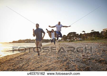Group of friends having fun on beach View Large Photo Image Stock Image - Group of friends having fun on beach. Fotosearch