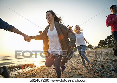Group of friends having fun on beach View Large Photo Image Stock Image - Group of friends having fun on beach. Fotosearch