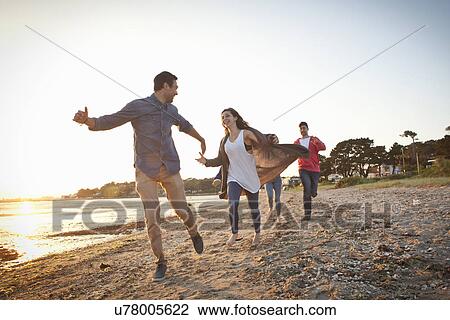 Group of friends having fun on beach View Large Photo Image Stock Image - Group of friends having fun on beach. Fotosearch