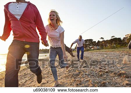 Group of friends having fun on beach View Large Photo Image Stock Photo - Group of friends having fun on beach. Fotosearch